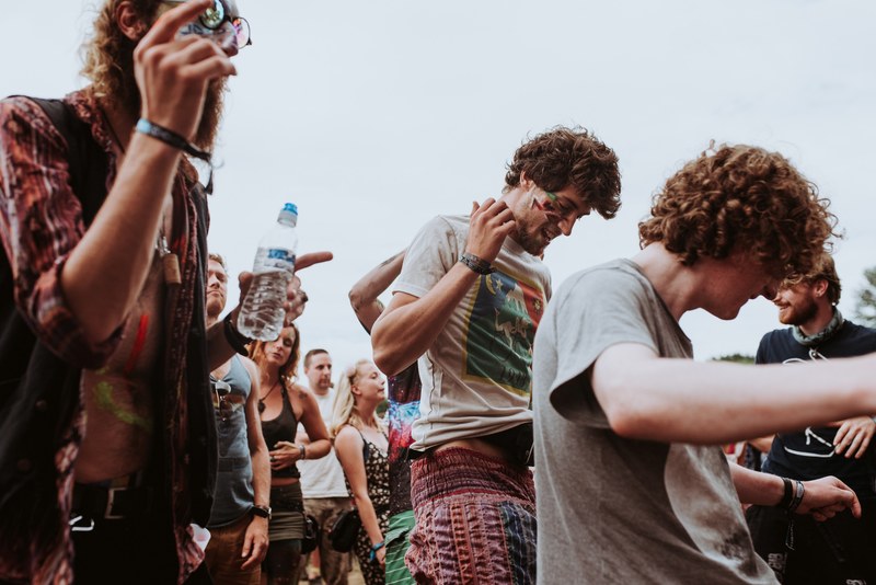 a group of young people enjoying themselves at a music festival, cheerful festival crowd 4k