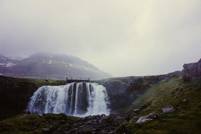 calm waterfall on a mossy hillside in iceland, misty waterfall in iceland 4k
