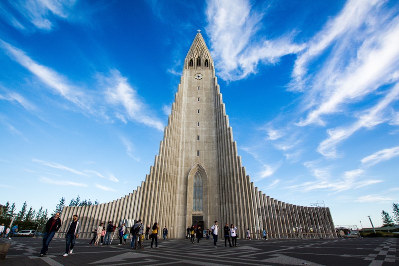 a group of people is standing in front of the hallgrimskirkja church, _people hallgrimskirkja church 4k