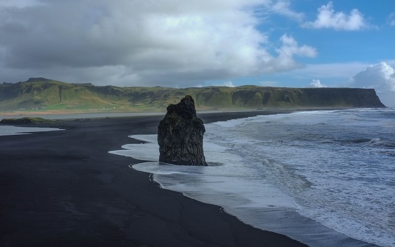 large rock on the black sand beach in reynisfjara, rock on black sand beach 4k