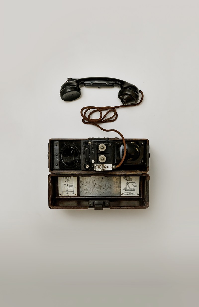 vintage telephone with a chord splayed on a white backdrop, vintage telephone 4k