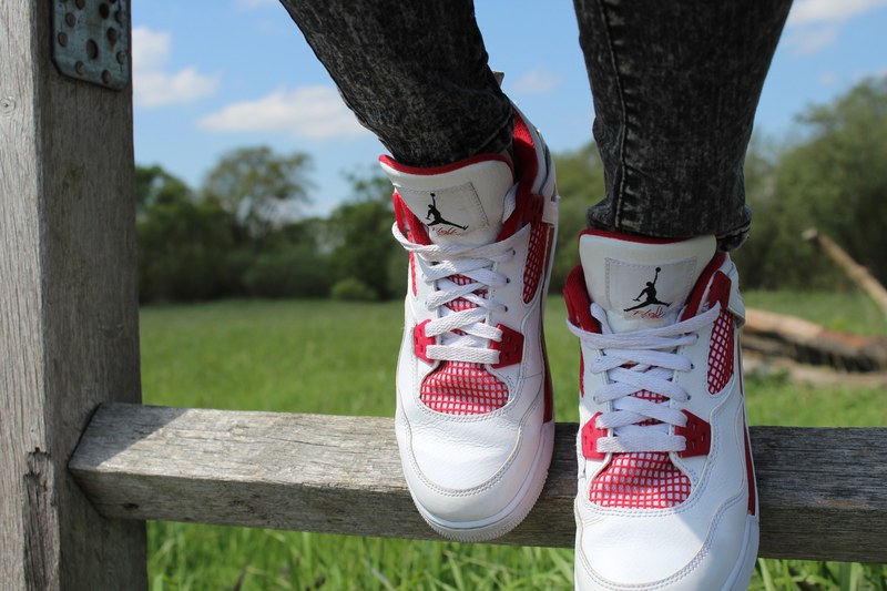 a person wearing air jordans and leaping off a fence in schwaig, jumping in jordans 4k