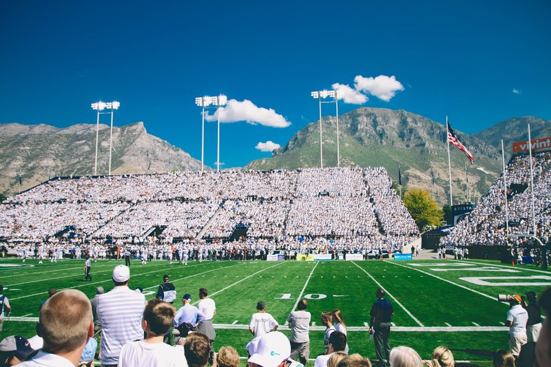 a football game viewed from in the bleachers close to the field, american football game 4k