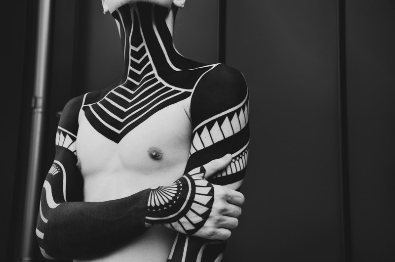 black and white shot of male torso with tattoos with black background kyiv city, jake davies 4k