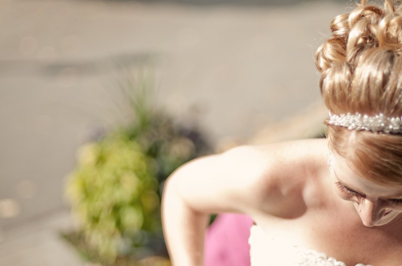 blonde bride with pearl headband looks down and smiles, bride wearing pearl headband 4k