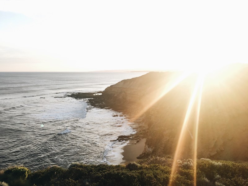 sunshine view of the rocky shoreline from a cliff at bells beach, rocky shoreline view 4k
