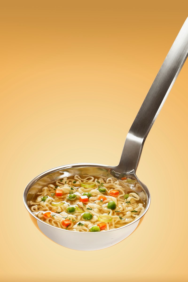 ladle full of vegetable soup with carrots peas and ramen noodles, ladle of ramen 4k