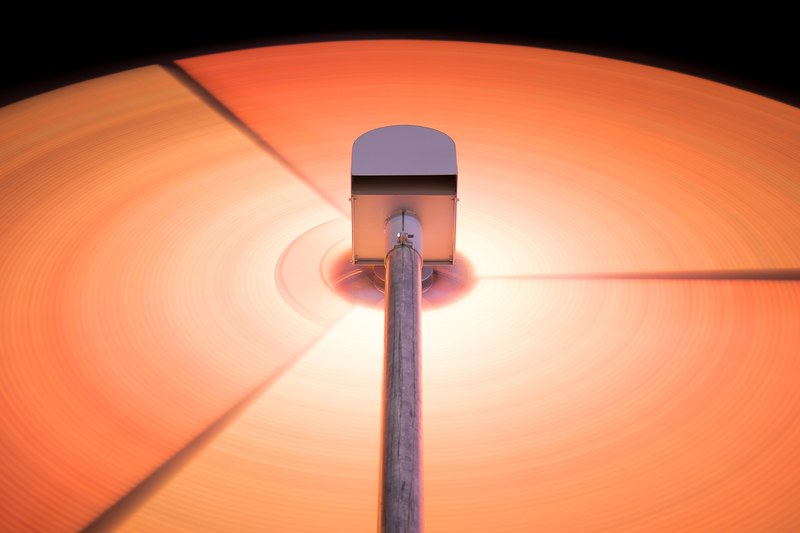 an orange record revolving under a metal stylus, orange vinyl and stylus 4k