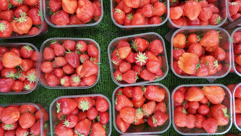 baskets of fresh red strawberries at a produce market, baskets of berries 4k
