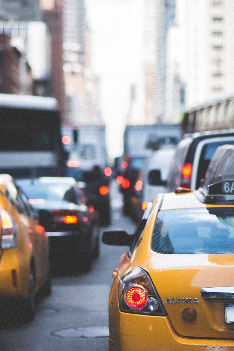 new york city street crowded with taxis cars and buses from the view of a driver, road rage 4k