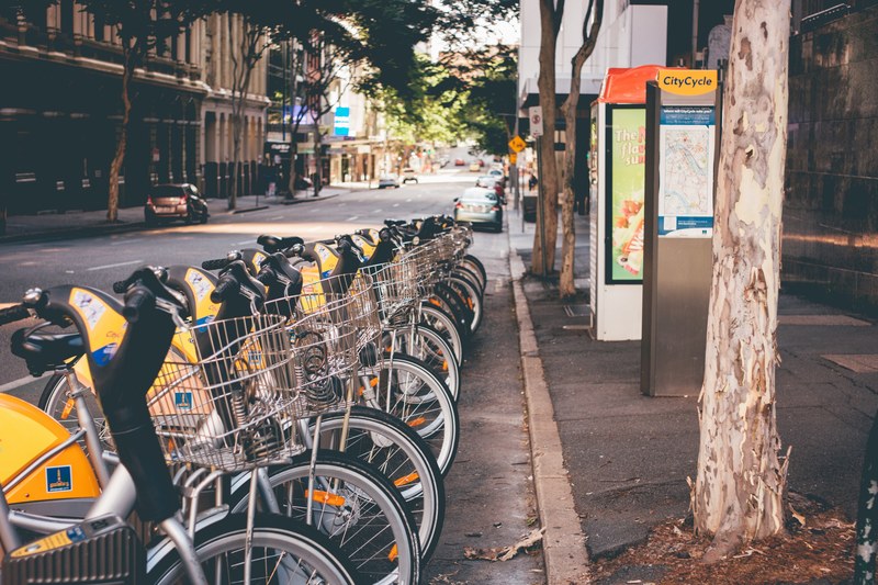 a row of bicycles at a bike sharing station, urban bike sharing station 4k