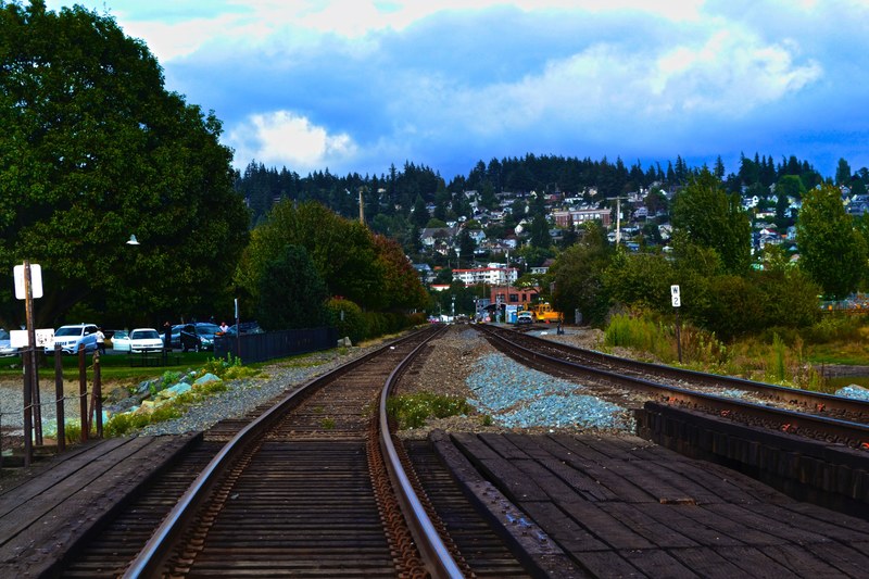 railway photography from on the tracks in a busy city from a front train window, train view of cityscape 4k