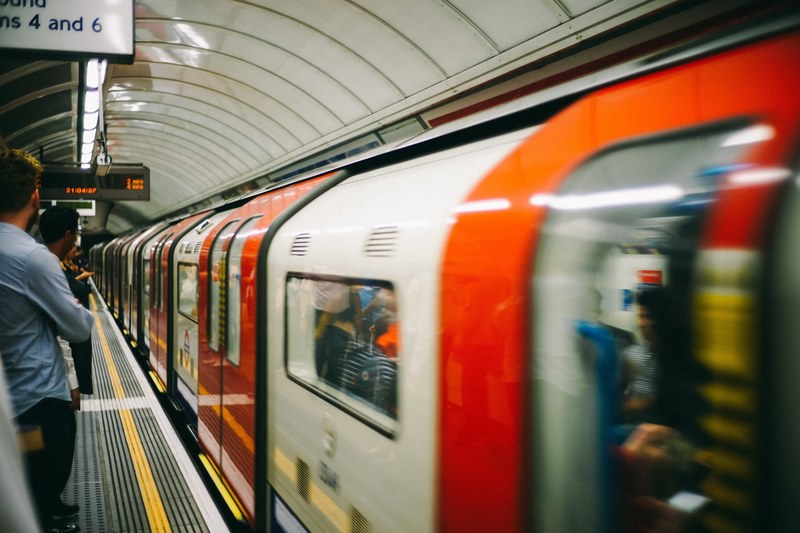 commuters standing on a platform as a subway train arrives in the london underground, in the london tube 4k