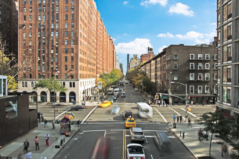 new york city intersection with taxis cars and buses driving and people walking, hustle and bustle 4k