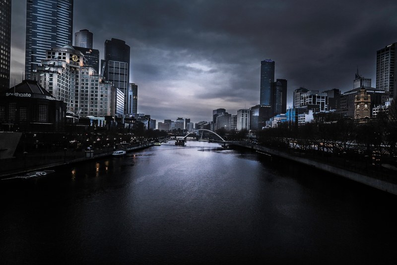 melbourne as seen over the water as day fades, water at night 4k
