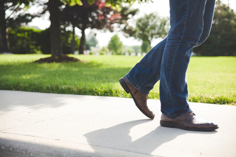 close up of a mans legs in jeans and brown shoes walking by the park, _legs jeans brown shoes 4k