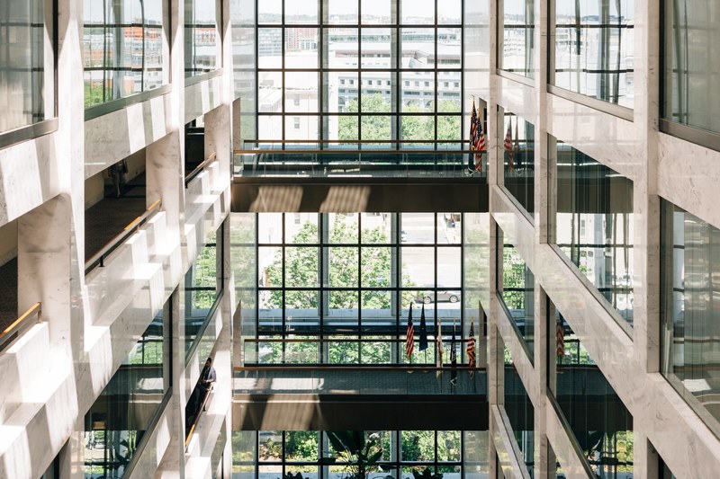 american flags near a window inside an office building of the us senate, flags in an office building 4k