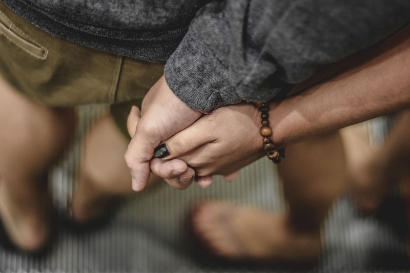 hand holding bracelet and beads 4k