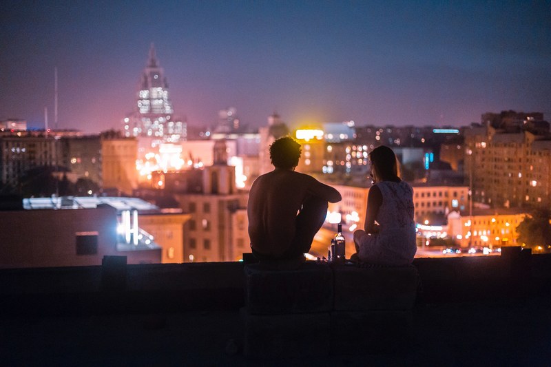 couple sits on a rooftop on a warm night in moscow, summer night 4k