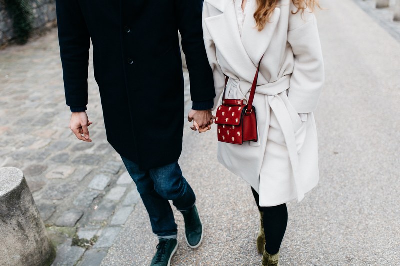 a fashionable couple holding hands while walking on the street, chilling lovers_ 4k