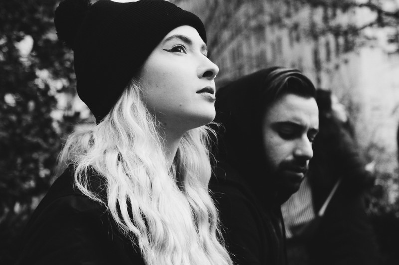 black and white shot of blonde haired woman in beanie and man in hood, young couple with beanie hood 4k