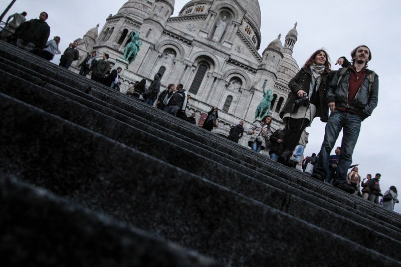a couple standing in front of a historic french building, _couple tourists france 4k