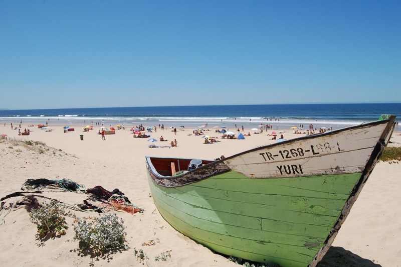 exciting scenes at lisbon beach featuring boat and the sunshine all over the shore, lisbon beach featuring boat 4k