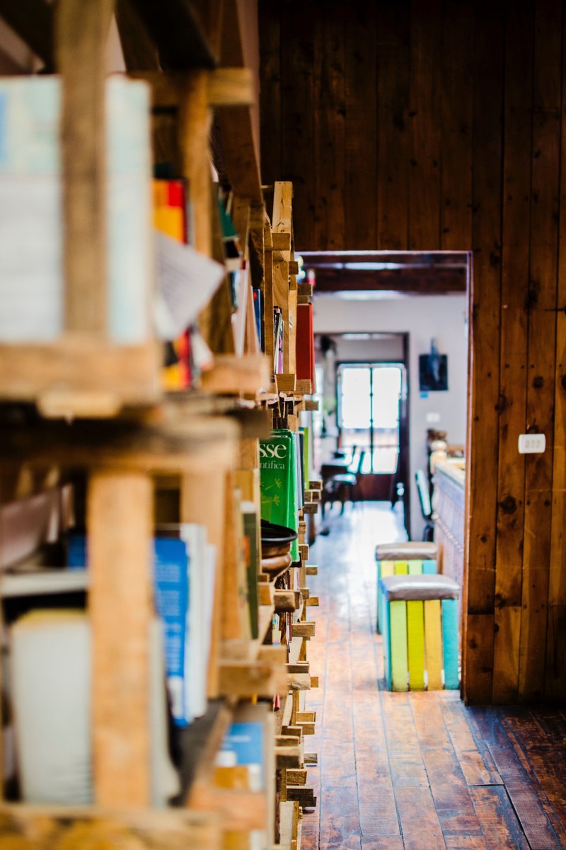 a side view of a bookcase with a view on a long corridor, side view of a bookcase 4k