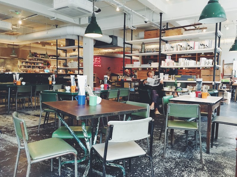 a man reading a newspaper in an empty caf, reading newspaper in a caf 4k