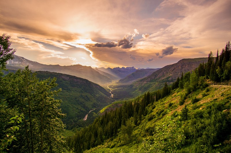 a magnificent scenery with a river in a shallow valley during golden hour, breathtaking valley 4k