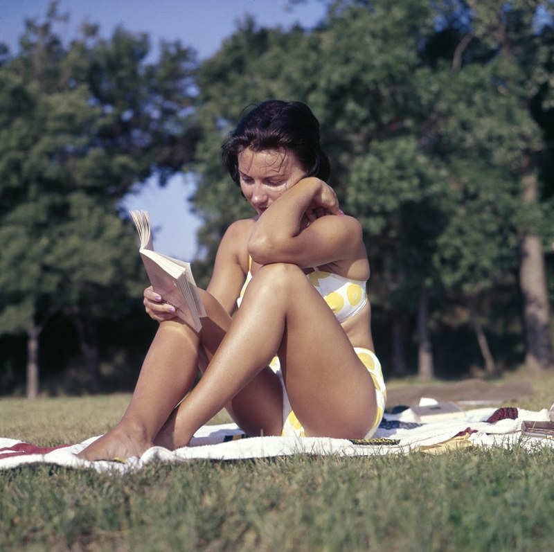 a woman in a swimsuit reading a book on the grass, _woman reading 4k
