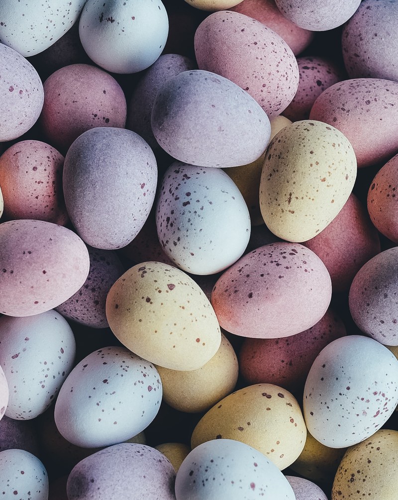 a close up macro shot of chocolate candy easter eggs, mini chocolate eggs 4k