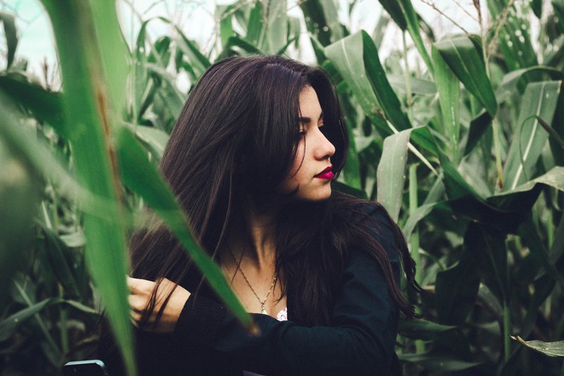 woman wear red lipstick standing alone in a cornfield, lonely and alone 4k