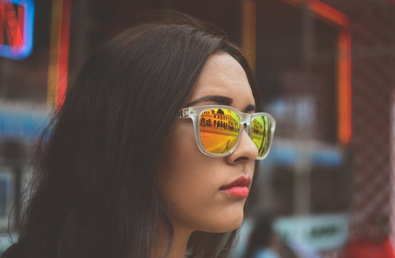 woman wearing reflective sunglasses looking out at a city street, reflective sunglasses 4k