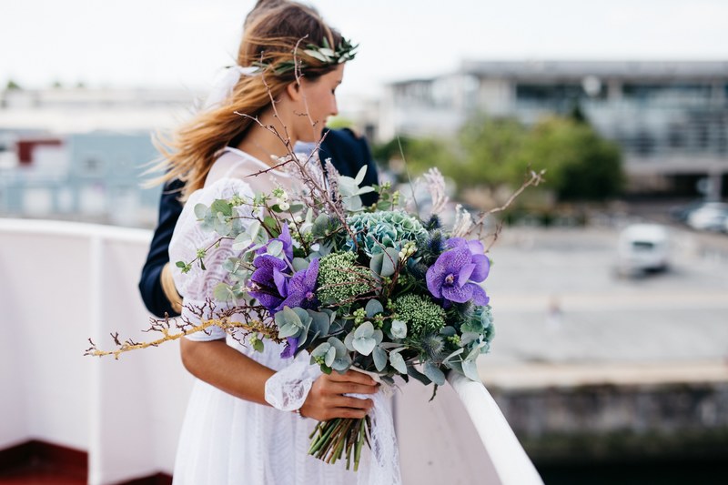 just married couple at an overlook in muse maritime de la rochelle with an ornate bouquet, bride holding a large bouquet 4k