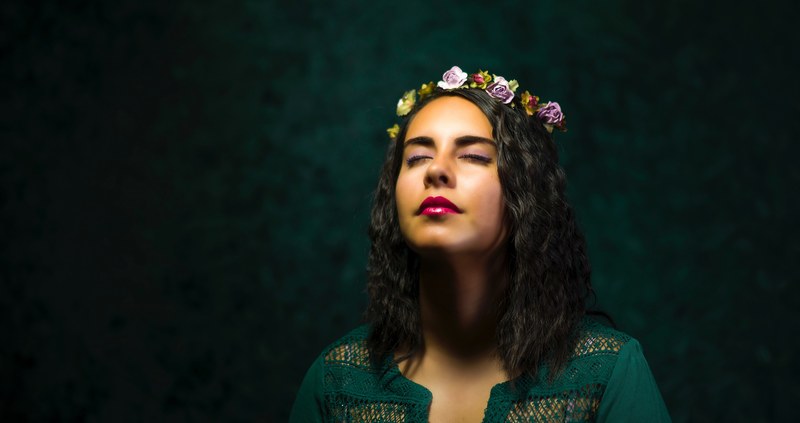a dark haired woman in a crown of flowers, young woman in a floral headband 4k