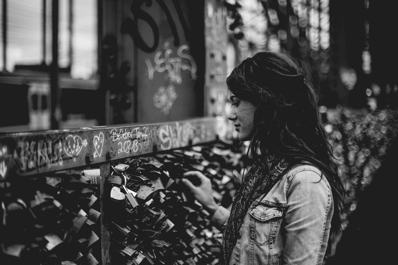 black and white shot of woman looking at graffiti and romantic padlocks in kln messedeutz, woman graffiti and padlocks 4k