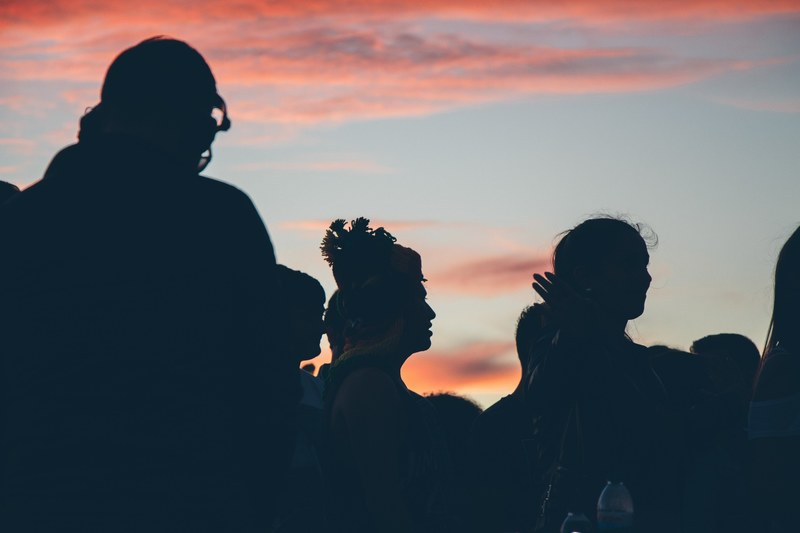 silhouette of a group of people watching something and standing under the sunset in leiria, leiria sunset crowd silhouette 4k