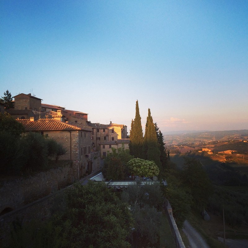 view of a village on the side of a hill with trees and stone houses, village on a hill 4k