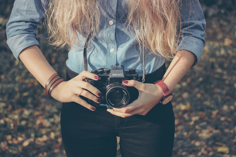 a close up of a woman holding a behnt zenit camera, _woman behnt zenit camera 4k