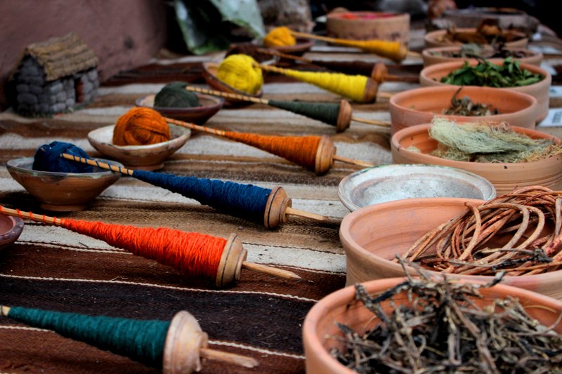 colored yarn and thread on a woven textile on a table at a market, market yarn 4k