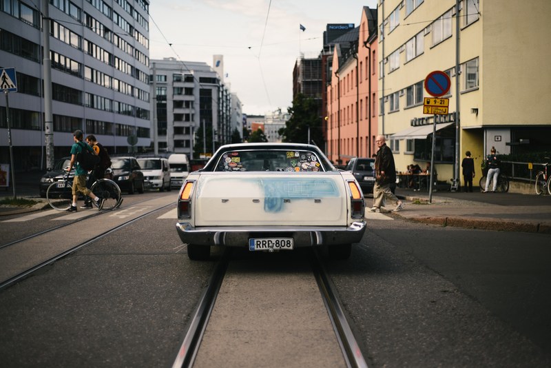 a vintage ford stops at a pedestrian crossing in kallio, white ford at a pedestrian crossing 4k