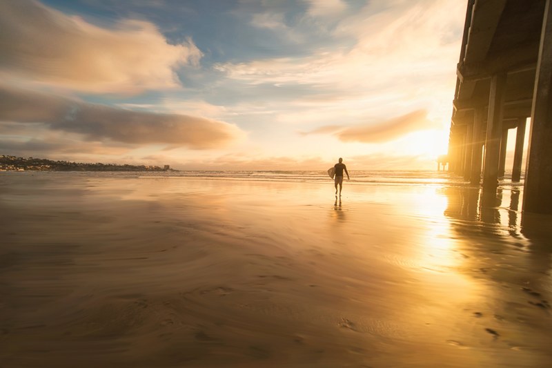 surfer walking away from ocean holding board during sunset in san diego, san diego surfer sunset 4k