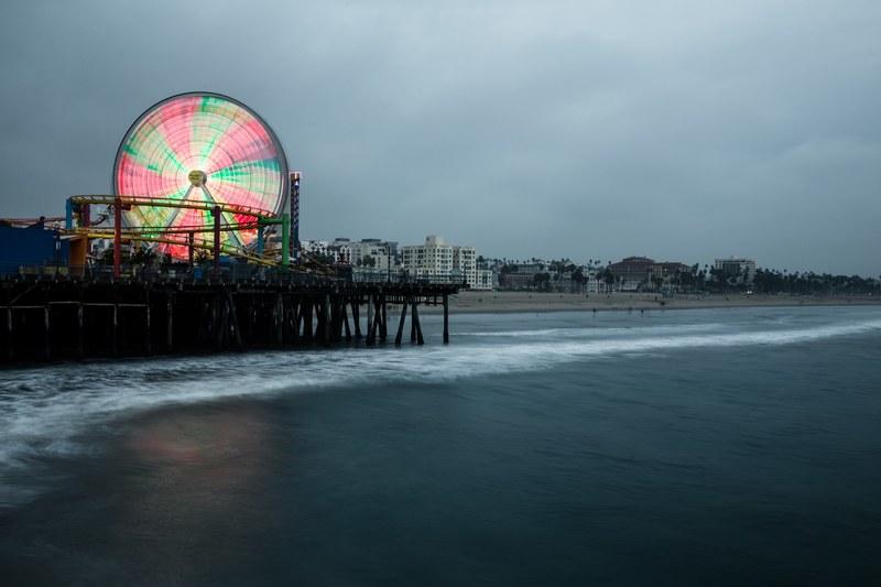 big colorful ferris wheel and a rollercoaster at the santa monica pier, ferris wheel on the pier 4k