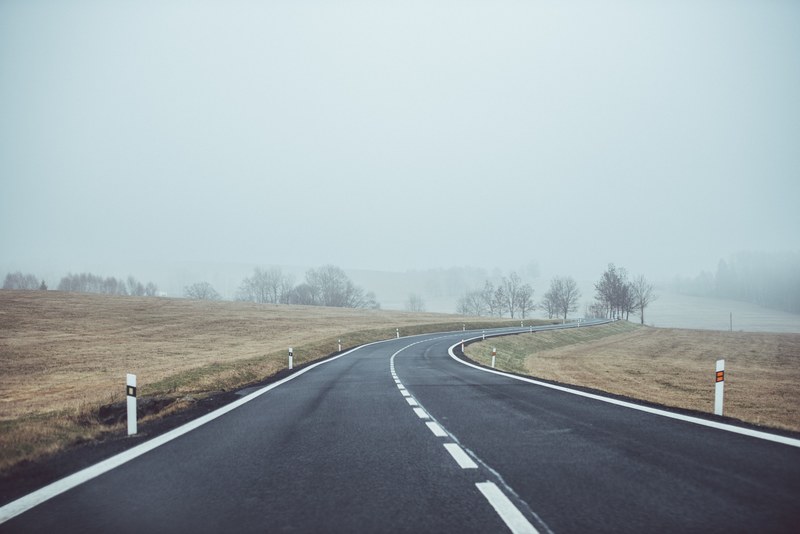 roads curve around the fields on a foggy day in umava national park, curving country roads 4k
