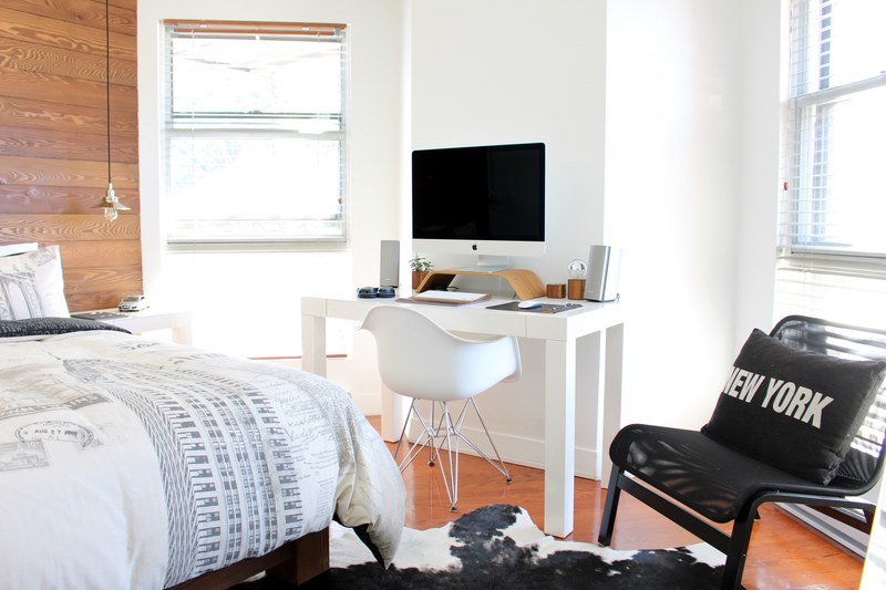 a bedroom with a large bed and a computer desk, ny loft bedroom 4k
