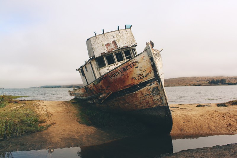 an abandoned old wrecked ship on the shore of the ocean at point reyes station, _abandoned boat on shore 4k