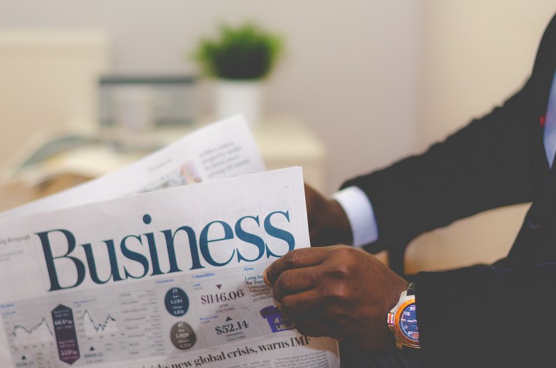 a businessman opening a business newspaper, businessman opening a paper 4k