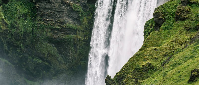 a large waterfall off a moss rock mountain in iceland, iceland rock mountain 4k