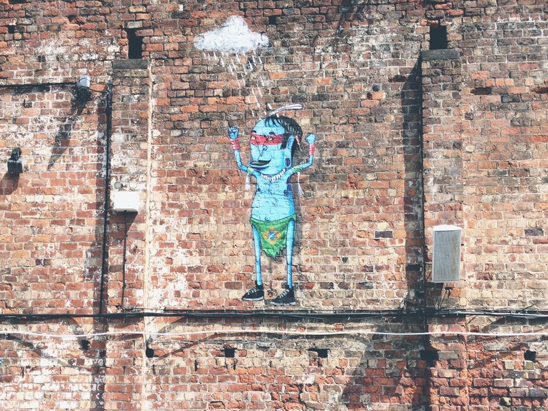 random cartoon art piece on plain brick wall in liverpool, cartoon art piece on brick wall 4k